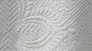 Detail of white-on-white quilt