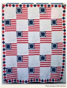 Bicentennial Quilt--contains images of Betsy Ross's original American flag alternating with white patches with eagle and star designs.